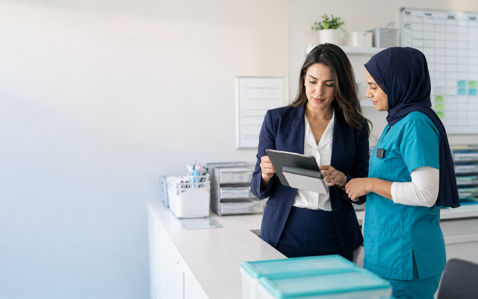 A clinic administrator and nurse reviewing an operations workflow together